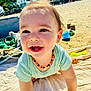 baby, beach, blanket, child, clothing, crawling, cute, daytime, happy, nature, necklace, outdoor, person, play, portrait, sand, smiling, sunlight, toddler, toys