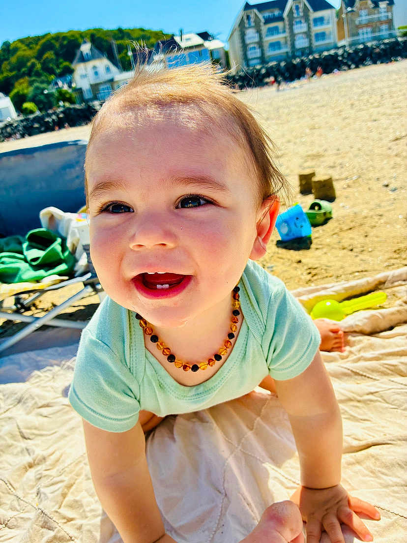 Léyo participe au concours pour gagner de l'argent avec cette photo : baby, beach, blanket, child, clothing, crawling, cute, daytime, happy, nature, necklace, outdoor, person, play, portrait, sand, smiling, sunlight, toddler, toys