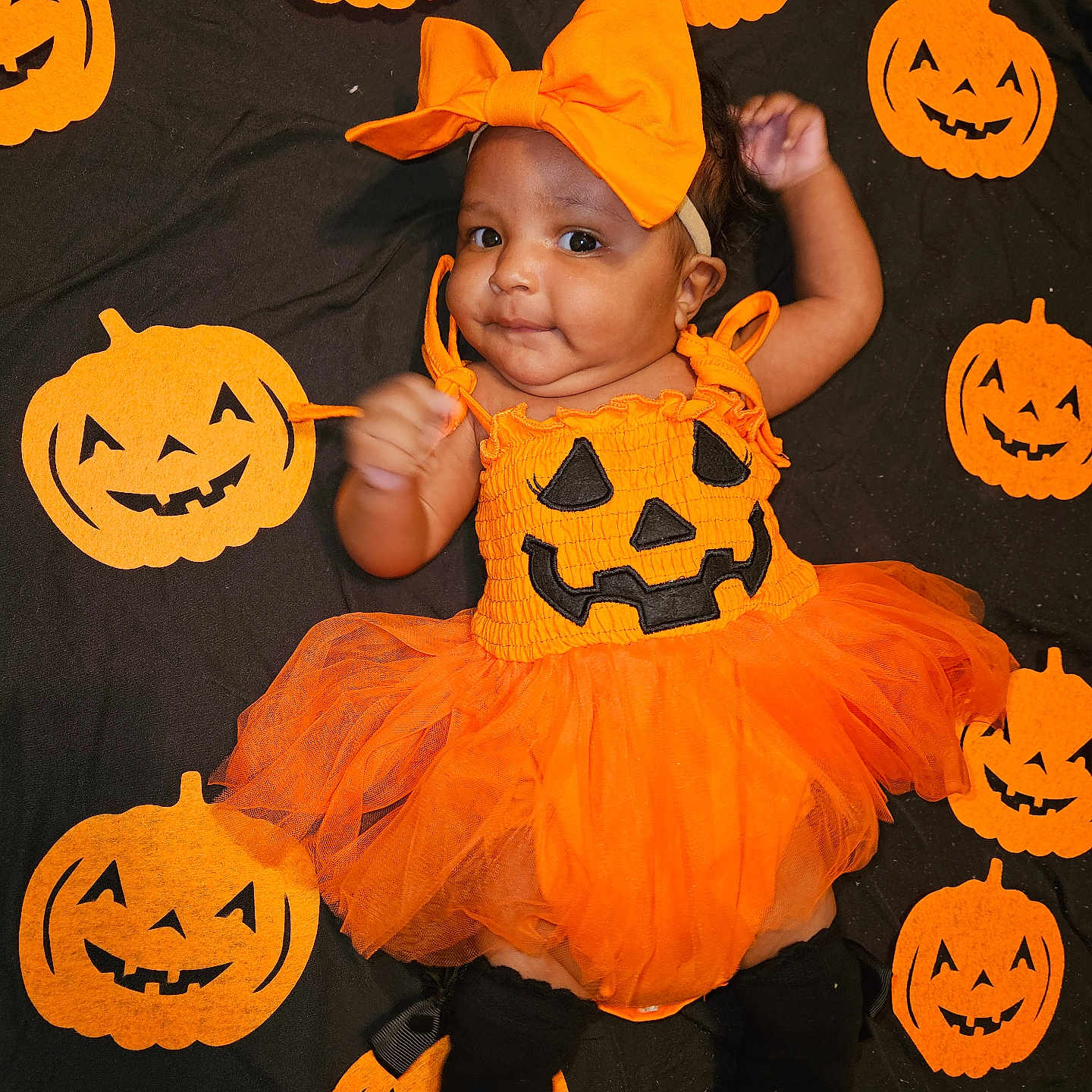 Simone is registered to the contest to win money with this photo: baby, bodypart, clothing, costume, face, festival, finger, food, halloween, hand, hat, head, jack_o_lantern, person, photography, plant, portrait, produce, pumpkin, vegetable