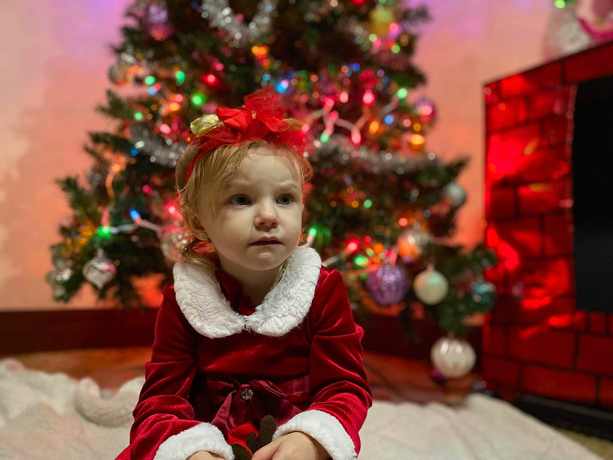 Legacy is registered to the contest to win money with this photo: child, christmas, christmas_decoration, christmas_eve, christmas_ornament, christmas_tree, conifer, event, evergreen, fun, happy, holiday, light, ornament, person, photograph, plant, red, toddler, tradition