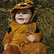 Samuel joined the competition — help win amazing prizes! apparel, baby, child, costume, couch, cute, fabric, face, hand, happy, hood, indoors, infant, person, plush, portrait, scooby_doo, seated, smile, warm_clothing