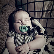 Samuel joined the competition — help win amazing prizes! baby, blanket, child, comfort, couch, cozy, cute, face, hands, indoors, infant, pacifier, peaceful, pillow, portrait, relaxing, resting, sleeping, soft_lighting, striped_clothing