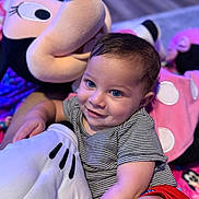 Karas joined the competition — help win amazing prizes! toddler, child, plush_toy, minnie_mouse, smile, blue_eyes, striped_shirt, red_shorts, indoor, soft_toy, cute, happy, cuddly, portrait, baby, person, closeup, cozy, playful, floor