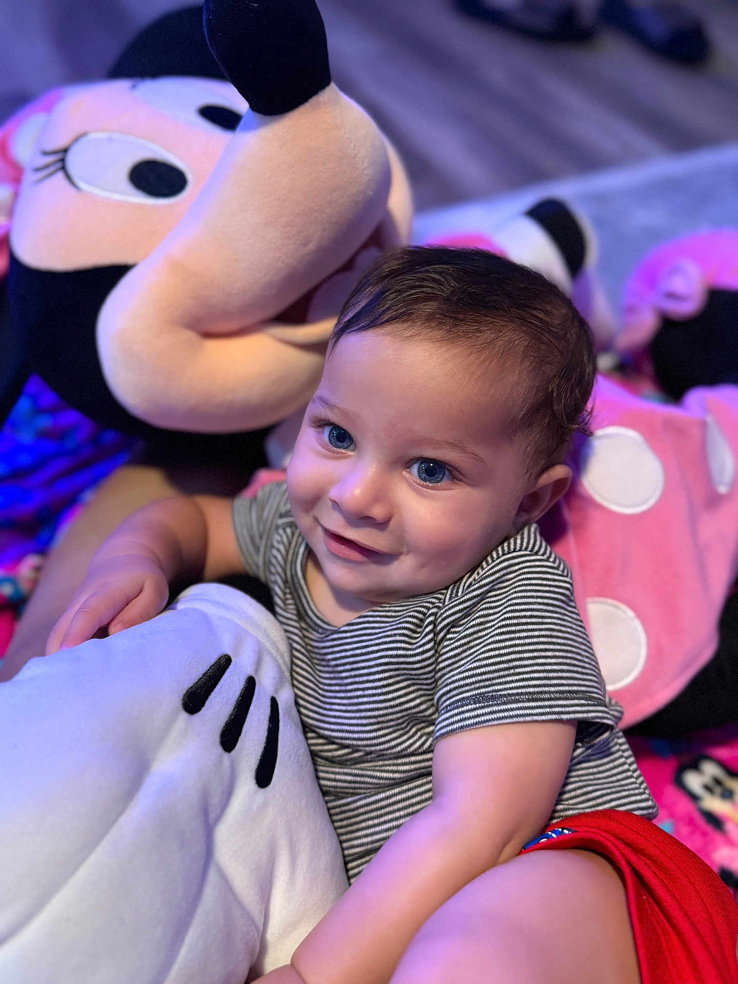 Karas joined the competition — help win amazing prizes! toddler, child, plush_toy, minnie_mouse, smile, blue_eyes, striped_shirt, red_shorts, indoor, soft_toy, cute, happy, cuddly, portrait, baby, person, closeup, cozy, playful, floor
