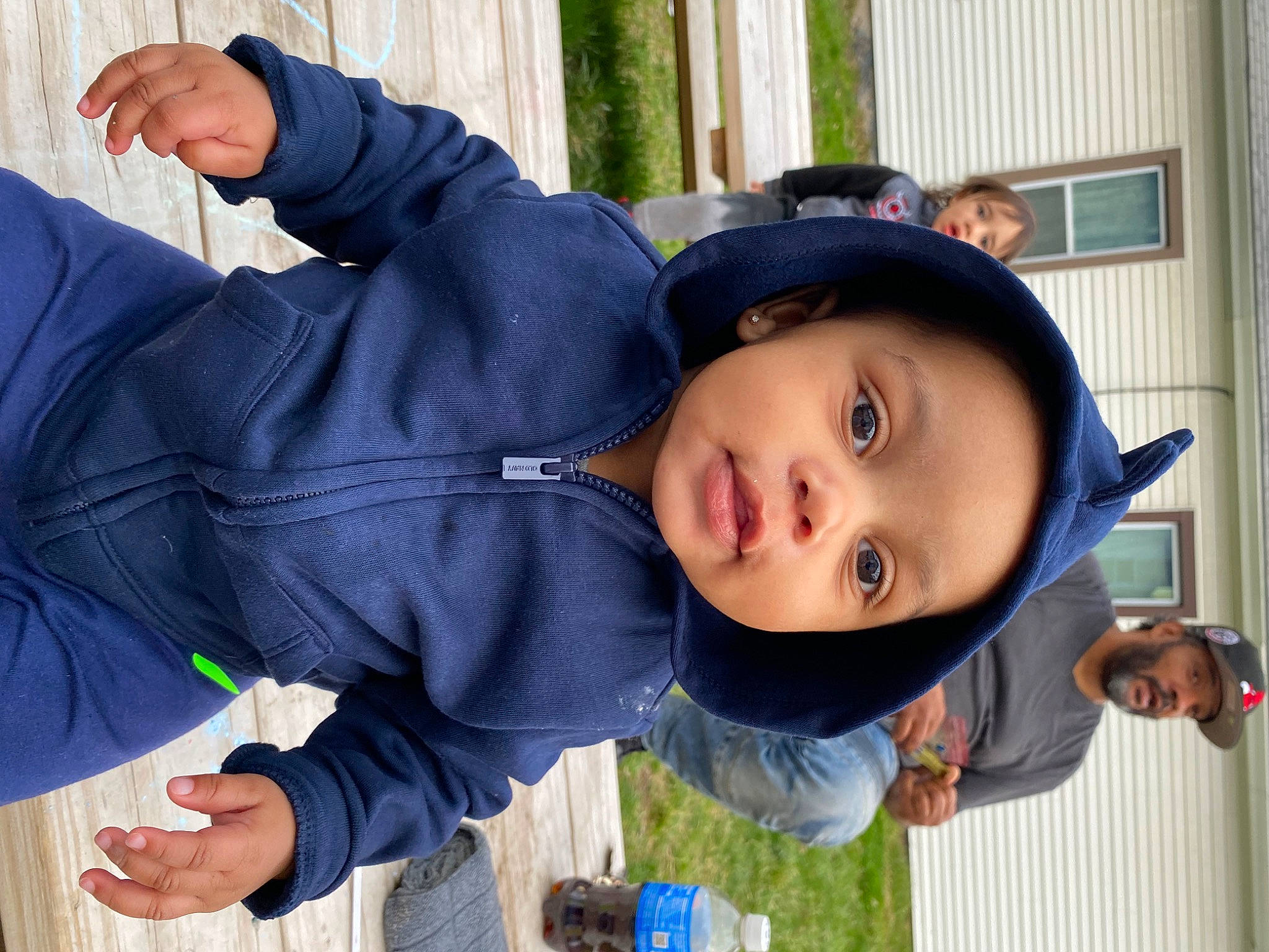 Liam is registered to the contest to win money with this photo: baby, child, electric_blue, fun, grass, happy, hat, headwear, jacket, leisure, nose, person, plant, play, recreation, smile, sun_hat, toddler, tree, vacation