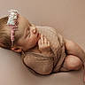 Remedy joined the competition — help win amazing prizes! newborn, baby, sleeping, headband, flower, swaddle, infant, portrait, soft_light, peaceful, cute, skin, delicate, hands, feet, lying_down, studio, child, closeup, blanket