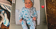 Remedy joined the competition — help win amazing prizes! baby, infant, child, toddler, baby_rocker, smile, headband, floral_clothing, blanket, carpet, indoor, furniture, playtime, happy, cute, family, sibling, blue_clothing, cozy, home