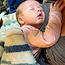 baby, sleeping, blanket, cuddle, cozy, comfort, infant, person, child, rest, soft, warm, striped_blanket, hand, face, nap, indoors, clothing, toddler, parent
