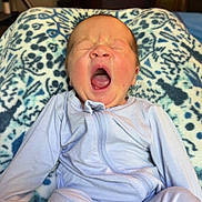 Remedy joined the competition — help win amazing prizes! baby, blanket, child, couch, cozy, cute, face, furniture, home, indoor, infant, newborn, pajamas, patterned_blanket, person, relaxing, sleepy, soft_lighting, television, yawning