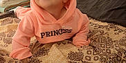 Manessa Ayna participe au concours pour gagner de l'argent avec cette photo : baby, bed, blanket, child, clothing, cozy, cute, face, happy, head, home, hoodie, indoor, infant, patterned_bedspread, person, pillow, pink_clothing, smiling, toddler