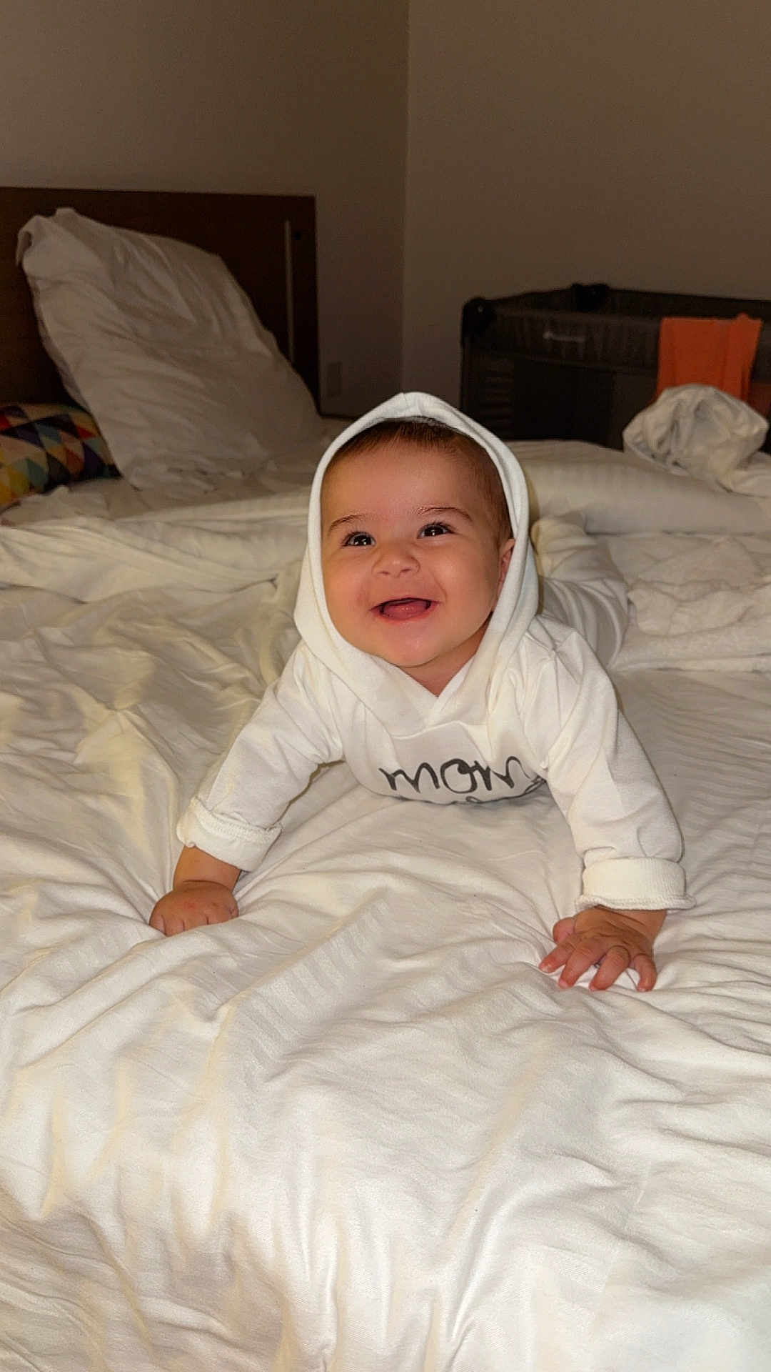 Manessa Ayna participe au concours pour gagner de l'argent avec cette photo : baby, bed, blanket, child, crawling, cute, furniture, happy, headwear, hoodie, indoors, infant, pajamas, person, portrait, room, sleeping_area, smile, white_clothing, young_child