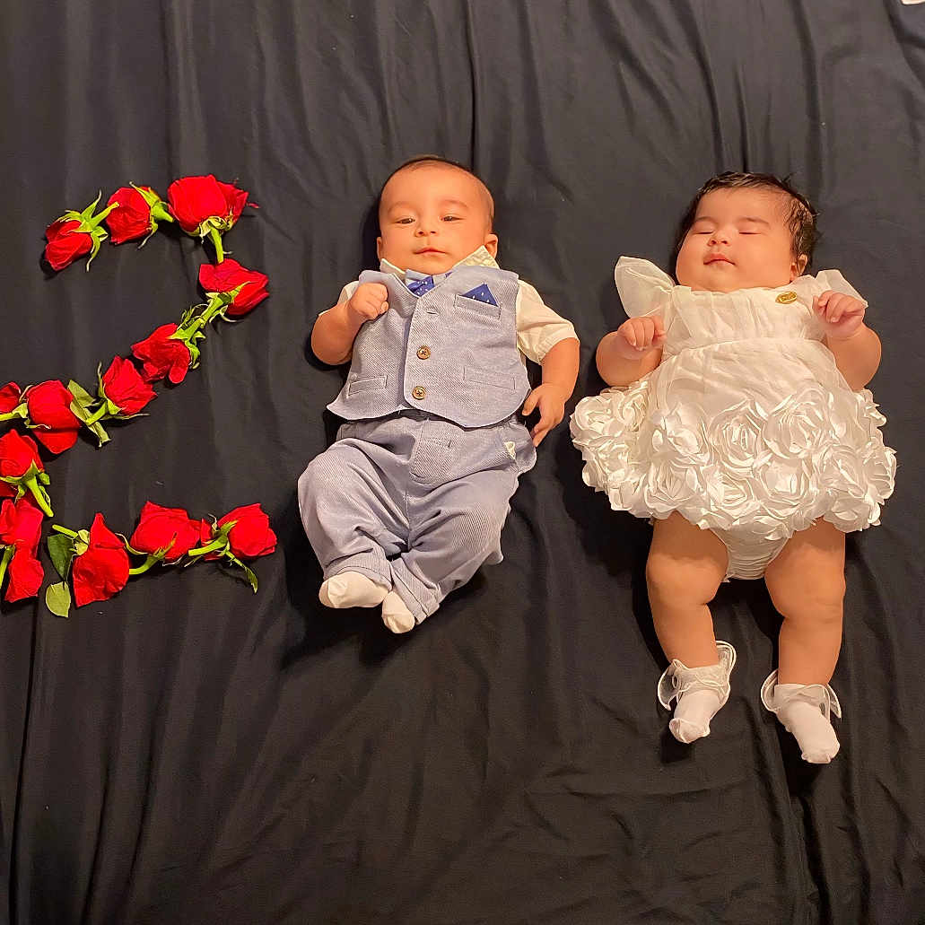 Yassmine is registered to the contest to win money with this photo: baby, baby_boy, baby_girl, blue_suit, celebration, cloth_background, cute, decorative, flower_arrangement, footwear, infant, lying_down, newborn, number_two, portrait, posing, roses, sleeping, smiling, white_dress