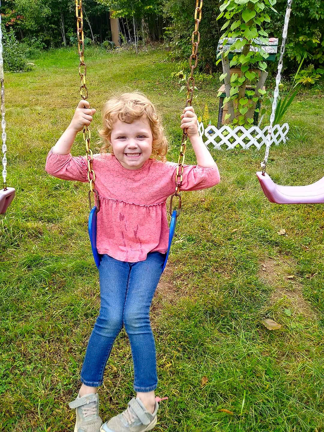 Catie is registered to the contest to win money with this photo: balance, boot, botany, child, fun, gesture, grass, green, happy, joy, leaf, leisure, nature, people_in_nature, person, plant, playground, smile, summer, terrestrial_plant