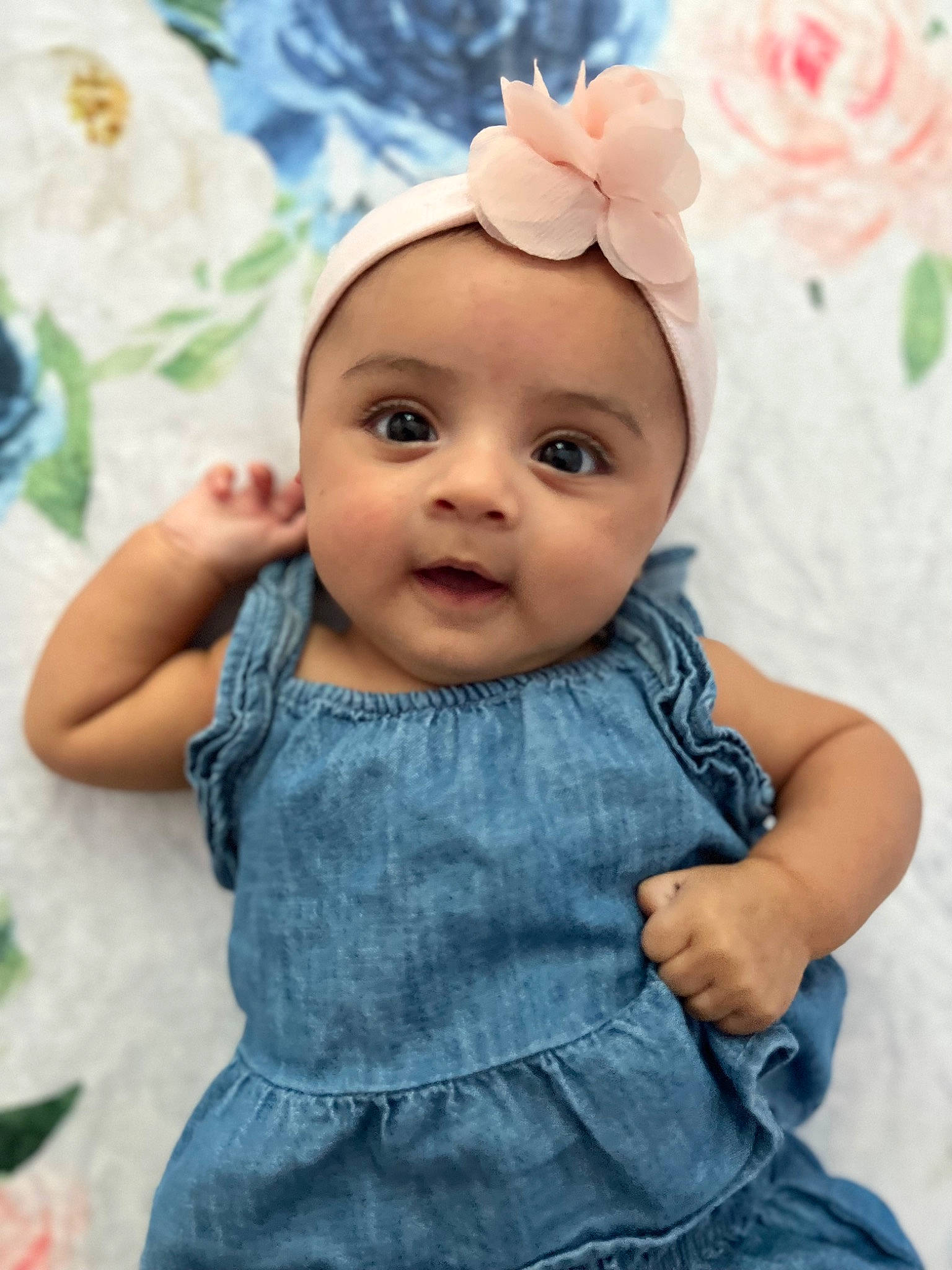 Reya is registered to the contest to win money with this photo: baby, baby_toddler_clothing, cheek, eye, finger, grass, happy, headgear, headwear, iris, lip, person, petal, pink, plant, purple, skin, sleeve, smile, textile