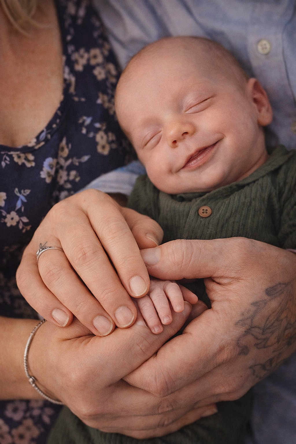 Jacob is registered to the contest to win money with this photo: baby, smiling, sleeping, hands, tattoo, ring, bracelet, adult, child, closeup, portrait, love, family, skin, clothing, fabric, holding, peaceful, toddler, comfort
