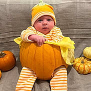 Henry joined the competition — help win amazing prizes! baby, pumpkin, orange, striped_pajamas, hat, blanket, fall, autumn, cute, child, sitting, face, footwear, decor, holiday, small_pumpkins, cozy, indoor, portrait, festive
