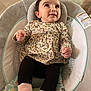 baby, infant, child, face, smile, floral_clothing, baby_chair, socks, indoor, floor, curious, seated, cute, soft_toys, comfortable, young, portrait, head, hands, legs
