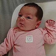 Kailee Jo is registered to the contest to win money with this photo: baby, infant, pink_clothing, striped_pajamas, lying_down, face, head, hand, soft_surface, blanket, cute, child, newborn, indoors, portrait, sleepwear, expression, person, cozy, young