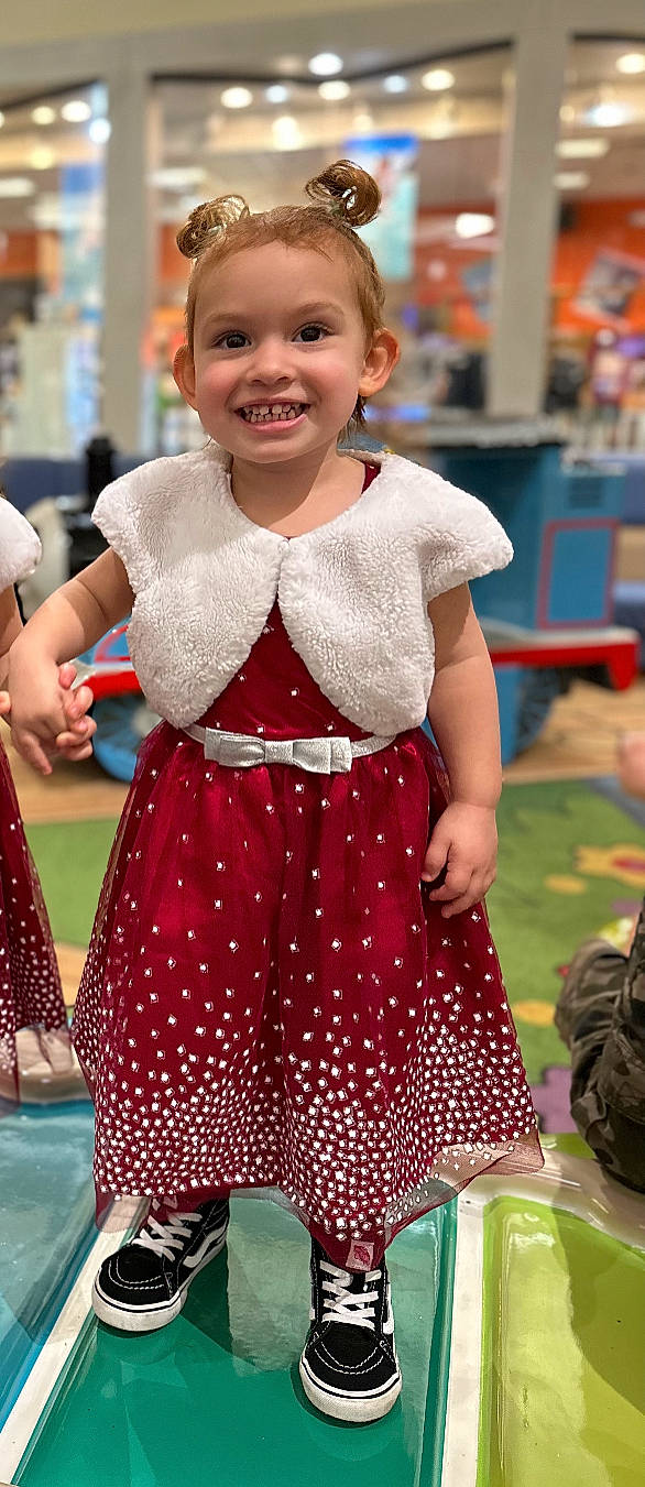 Stevie is registered to the contest to win money with this photo: child, dress, event, facial_expression, fashion_design, fun, hairstyle, happy, human_leg, joy, magenta, pattern, person, photograph, pink, recreation, sleeve, smile, snapshot, thigh