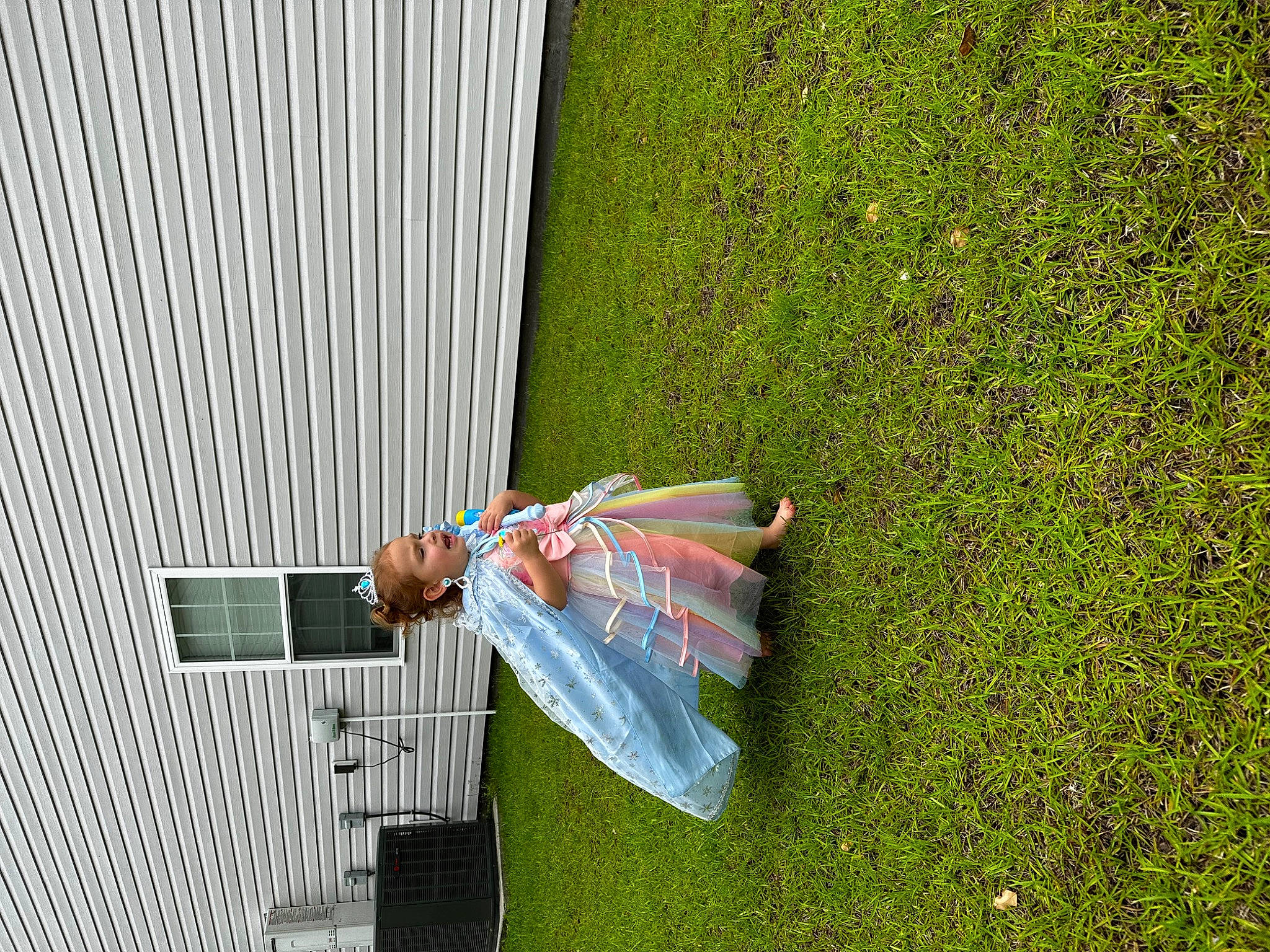 Stevie is registered to the contest to win money with this photo: building, fun, grass, grassland, groundcover, house, landscape, leisure, outdoor_furniture, people_in_nature, person, plant, recreation, shade, shadow, shrub, slope, tree