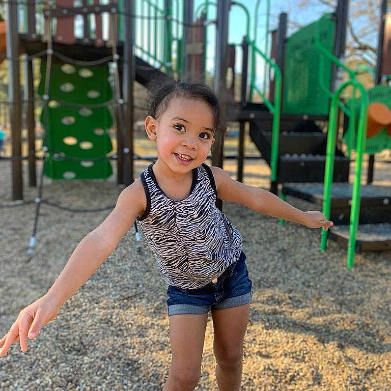 Avaery is registered to the contest to win money with this photo: active, barefoot, casual_clothing, child, climbing_structure, daylight, fun, gravel, happy, nature, outdoor, park, person, play_equipment, playground, shorts, smiling, summer, tank_top, young