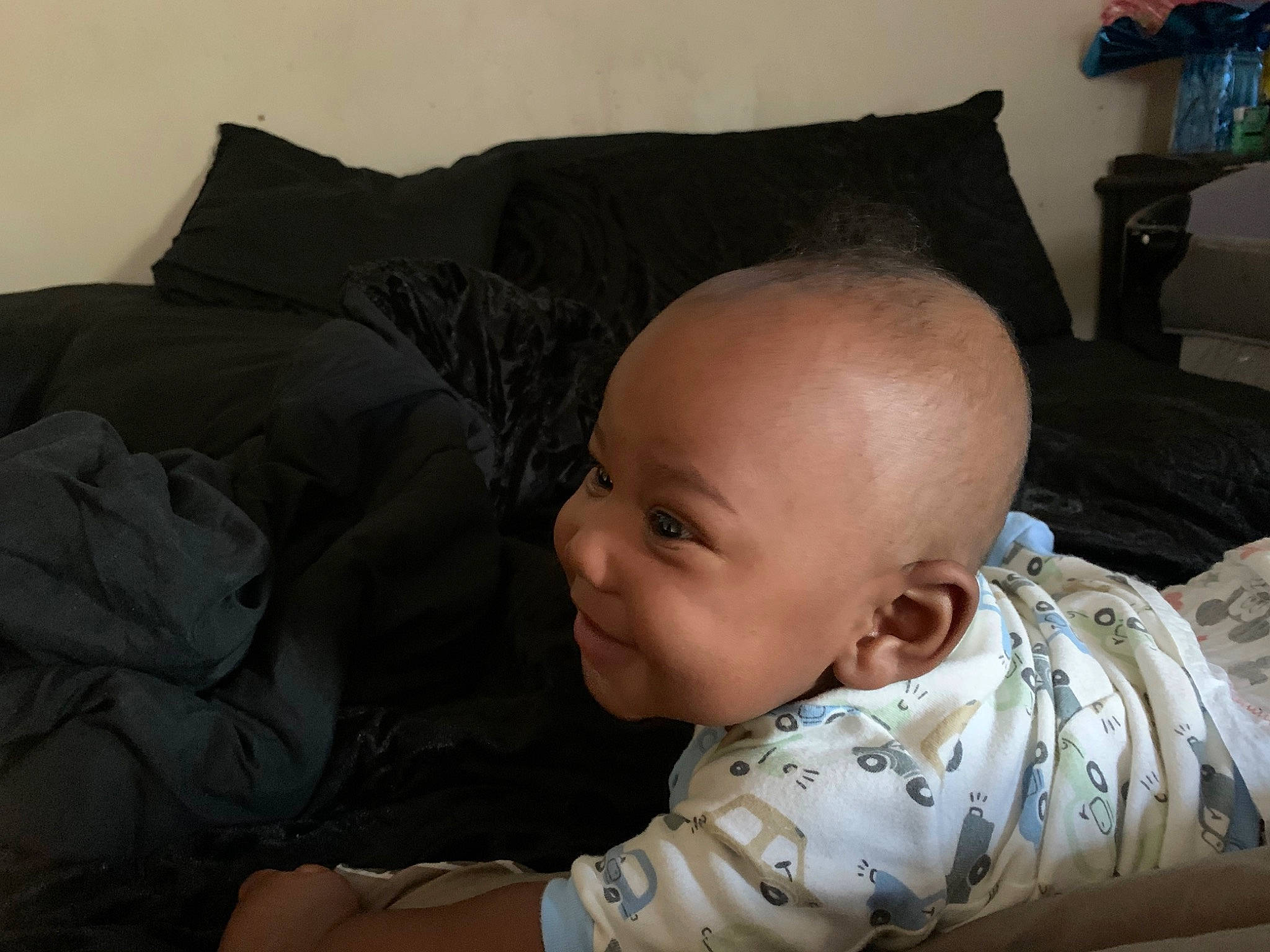 Hezekiah is registered to the contest to win money with this photo: baby, baby_products, baby_toddler_clothing, bedding, bedtime, cheek, child, comfort, couch, elbow, linens, living_room, person, pillow, room, sitting, sleeve, smile, throw_pillow, toddler