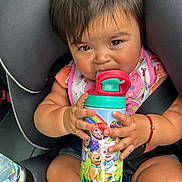 Amelia is registered to the contest to win money with this photo: baby, bottle, clothing, couch, cream, cushion, dessert, face, food, furniture, head, homedecor, icecream, person, photography, portrait, shaker, shorts, sitting, tape