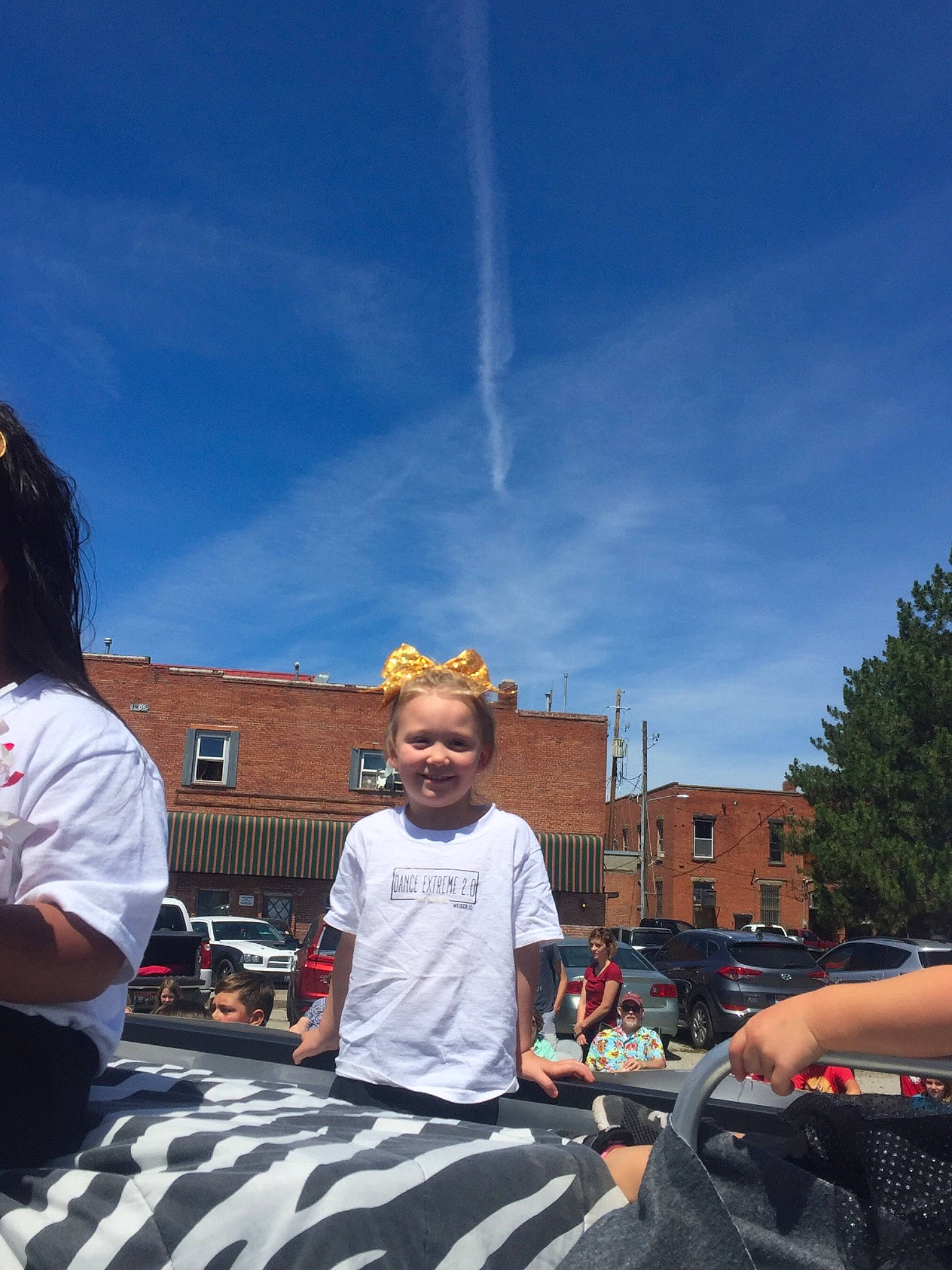 Karlee joined the competition — help win amazing prizes! car, child, city, cloud, joy, luxury_vehicle, meteorological_phenomenon, motor_vehicle, mountain, person, plant, recreation, road, sky, smile, street, summer, t_shirt, tourism, tree