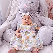 Malya participe au concours pour gagner de l'argent avec cette photo : baby, child, plush_toy, stuffed_animal, bunny, dress, headband, smiling, sitting, indoor, cozy, cute, soft_toy, happy, infant, decor, bed, comfort, person, portrait