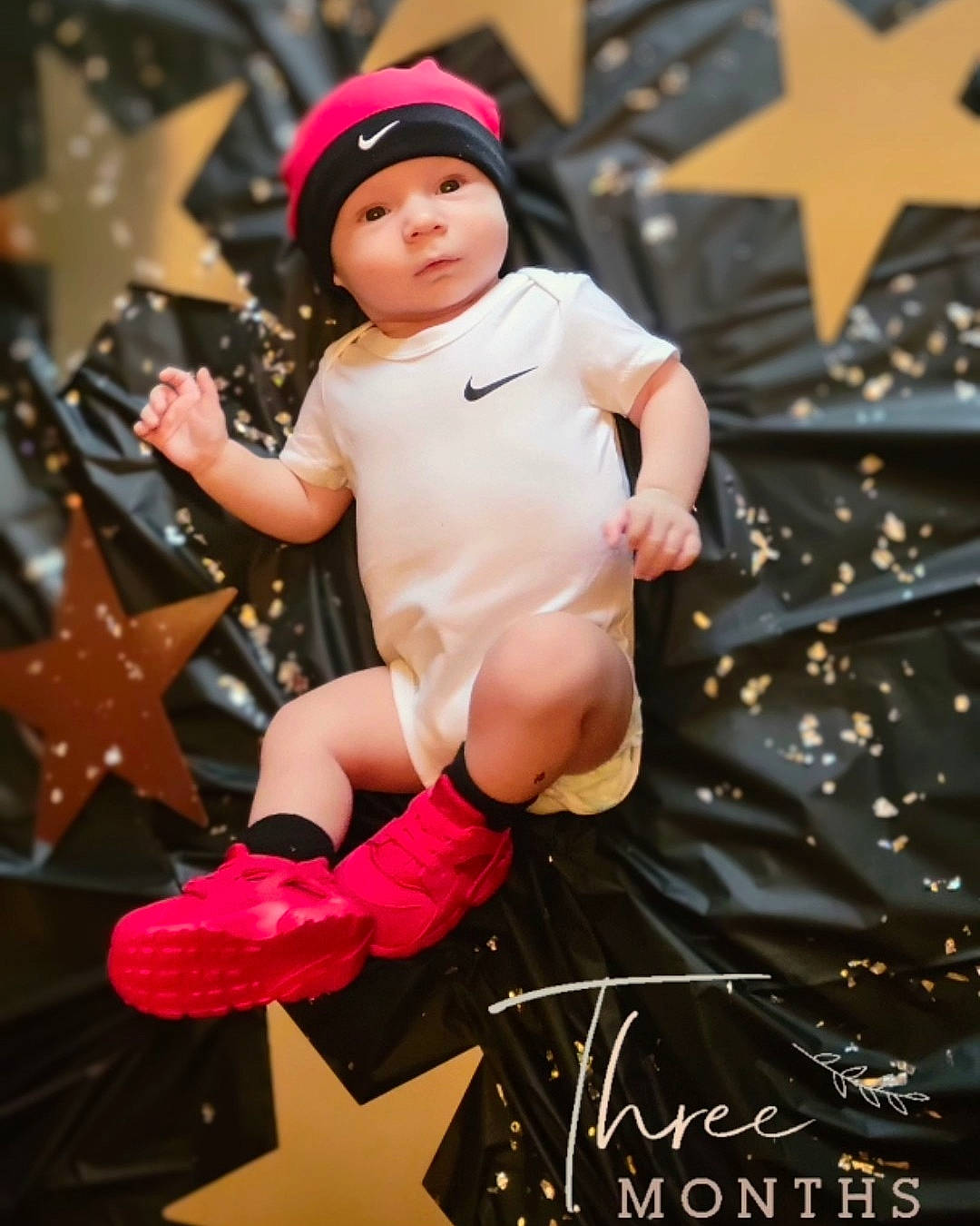 Nixon joined the competition — help win amazing prizes! abdomen, baby, cap, carmine, child, costume, entertainment, event, fictional_character, flash_photography, fun, glove, happy, headwear, human_leg, magenta, person, pink, sitting, sock