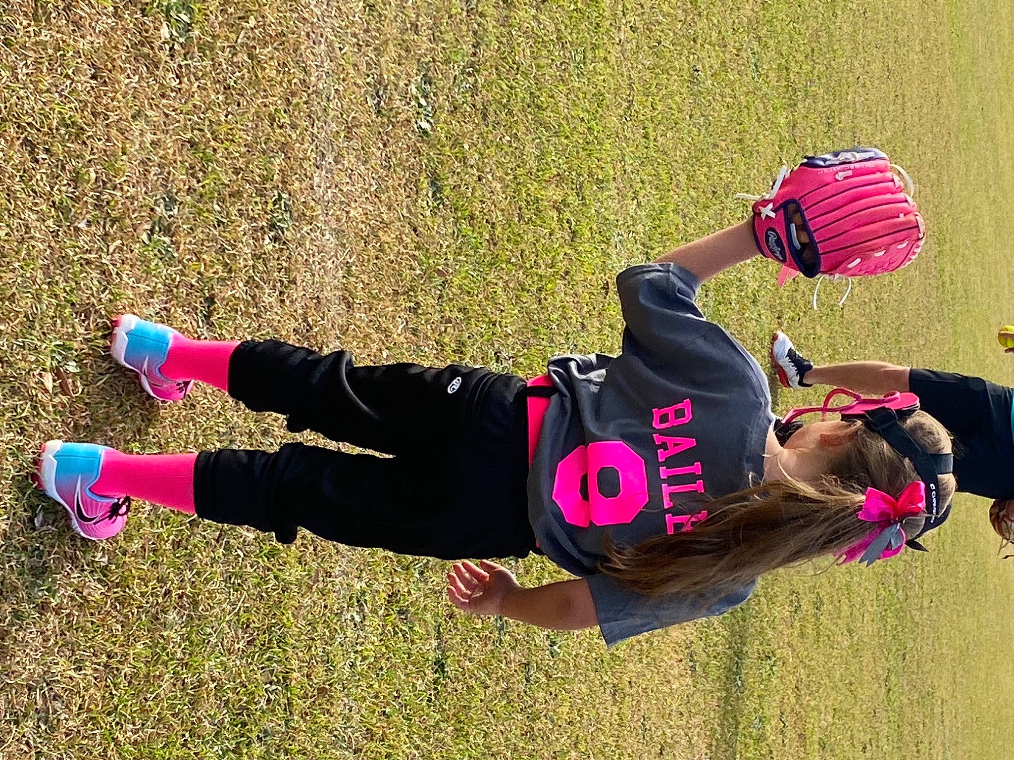 Bailee is registered to the contest to win money with this photo: clothing, competition_event, fun, grass, hat, knee, leisure, people_in_nature, physical_fitness, player, recreation, shoe, shorts, sneakers, sock, sports, sports_gear, sportswear, sweatpant, thigh