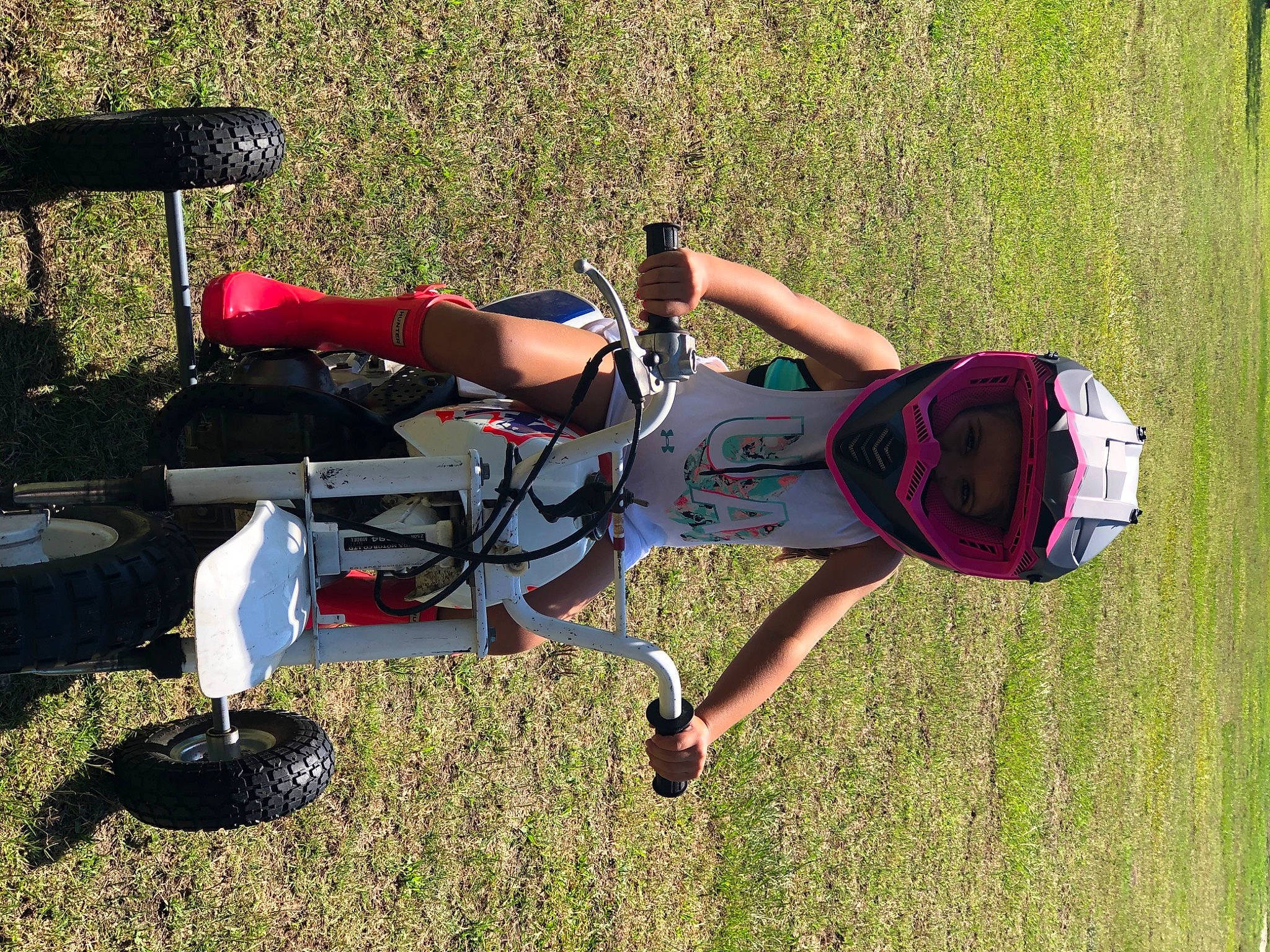 Bailee is registered to the contest to win money with this photo: chair, elbow, fun, grass, grassland, headwear, human_leg, knee, leg, leisure, outdoor_recreation, person, plant, recreation, sports, under_exposed, vehicle