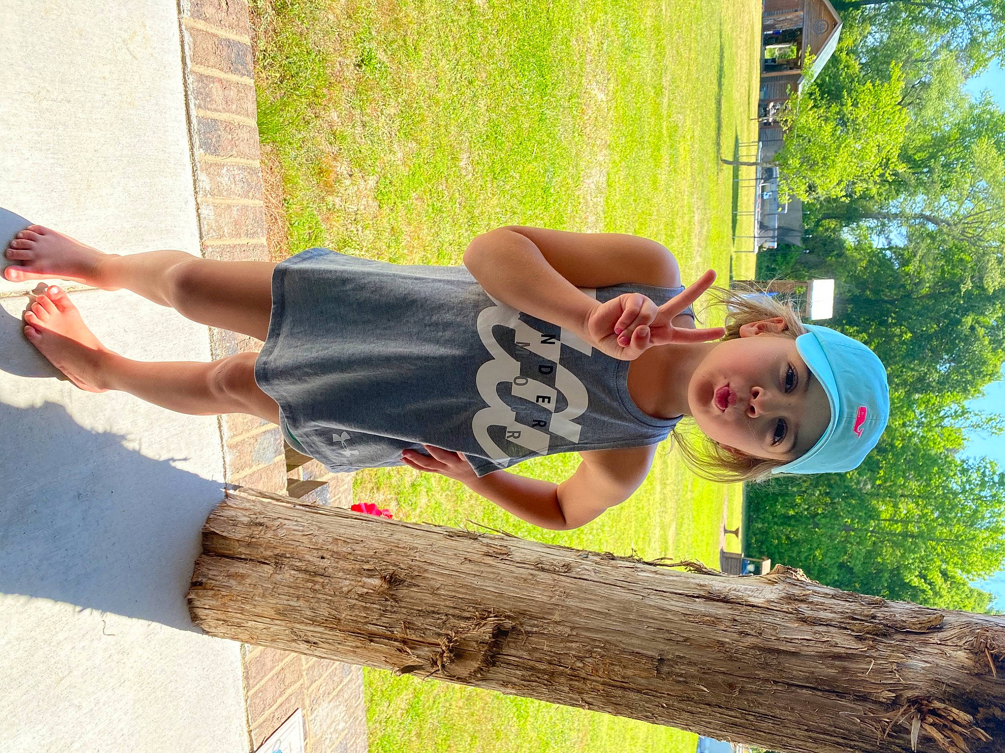 Bailee is registered to the contest to win money with this photo: calf, elbow, eyewear, fun, grass, happy, hat, headwear, human_leg, knee, leisure, people_in_nature, person, recreation, sitting, sky, street_fashion, thigh, tree, trunk