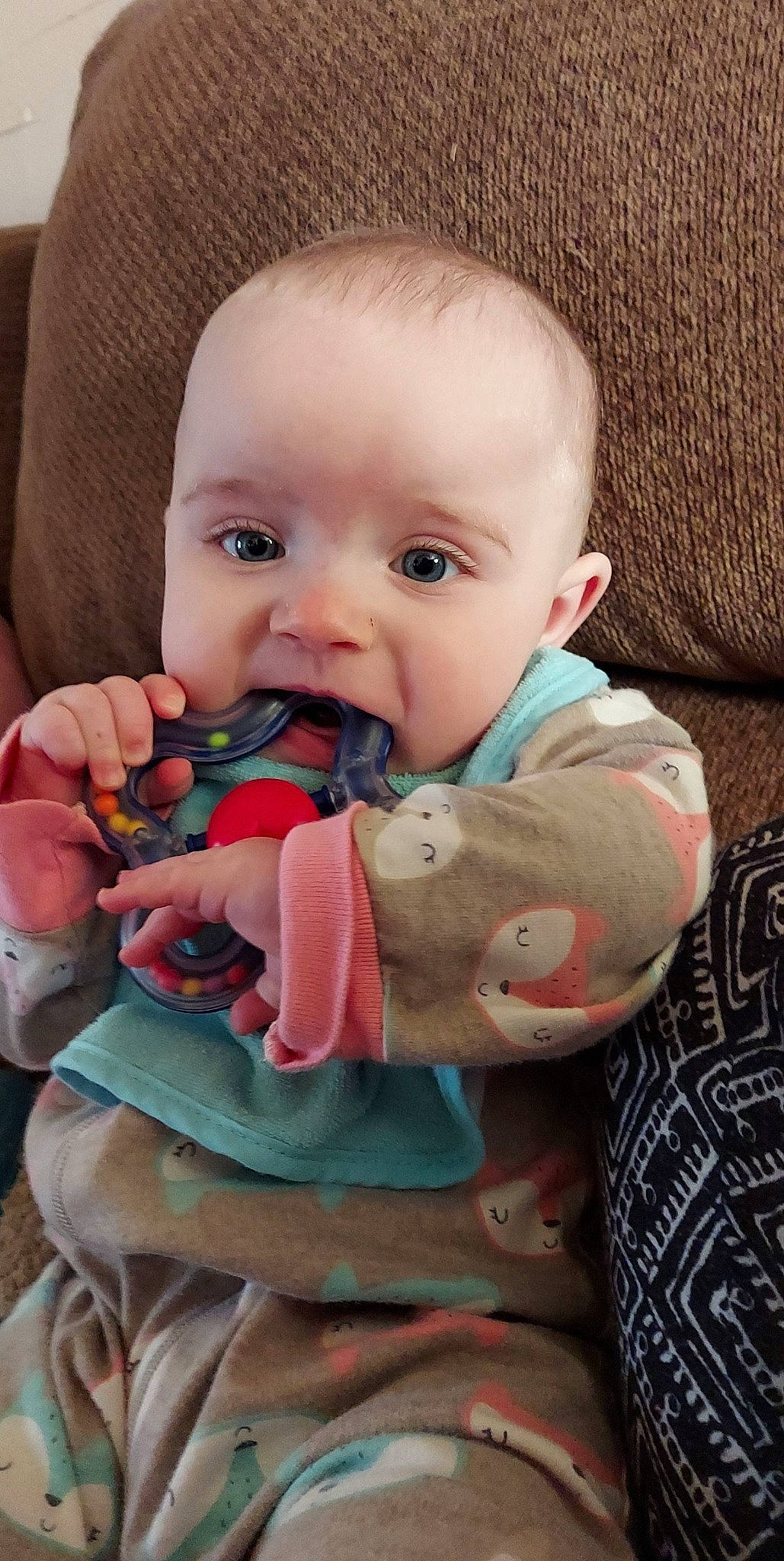 Emmerson is registered to the contest to win money with this photo: baby, baby_products, baby_toddler_clothing, cheek, child, comfort, face, finger, iris, lip, mammal, mouth, nail, nose, person, pink, product, sitting, skin, textile