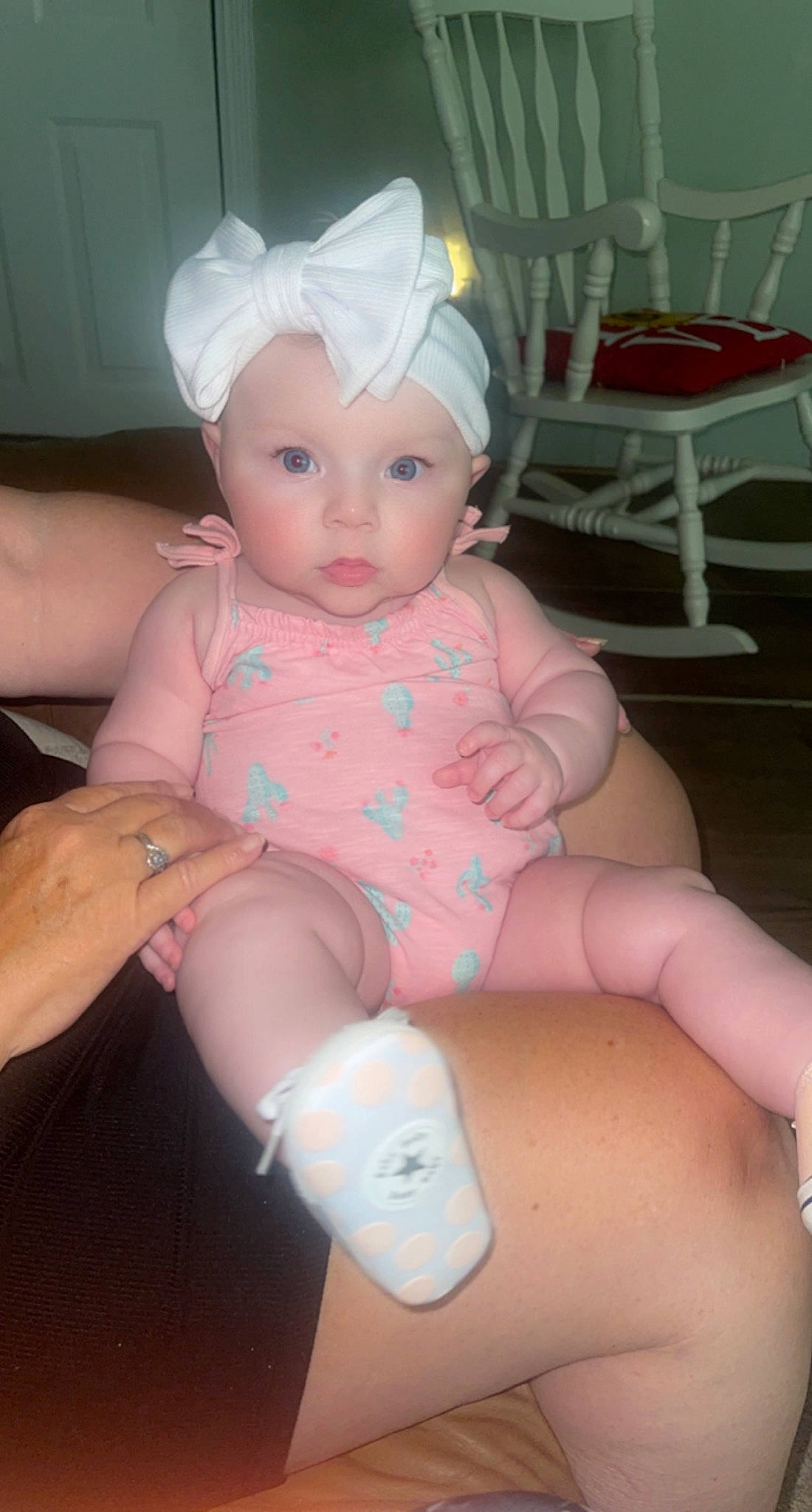 Naomi is registered to the contest to win money with this photo: arm, baby, baby_toddler_clothing, chair, cheek, eye, finger, hand, head, headwear, joint, knee, leg, mouth, nail, person, pink, skin, stomach, thigh
