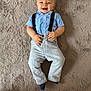 Elijah participe au concours pour gagner de l'argent avec cette photo : baby, child, smiling, blue_shirt, suspenders, pants, carpet, floor, cute, happy, infant, portrait, one_person, indoors, casual_clothing, lying_down, small_child, light_clothing, human, baby_boy