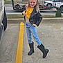 Kadason joined the competition — help win amazing prizes! child, girl, yellow_bow, yellow_top, black_leather_jacket, blue_jeans, black_boots, posing, smiling, parking_lot, concrete, vehicle, car, road, outdoor, fashion, happy, casual_wear, cute, confident