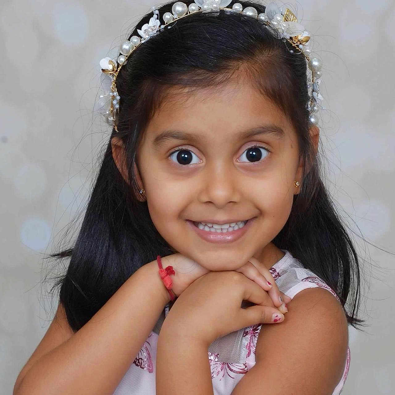 Veera is registered to the contest to win money with this photo: accessories, blackhair, bodypart, child, clothing, dimples, dress, face, female, girl, hair, happy, head, jewelry, person, photography, portrait, shoulder, smile, tiara