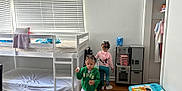 Jalynn Jr is registered to the contest to win money with this photo: child, children, bunk_bed, bedroom, toy_kitchen, activity_table, carpet, window_blinds, wooden_floor, clothing, hair_beads, play, indoor, furniture, person, room, white_wall, sneakers, pajamas, ladder