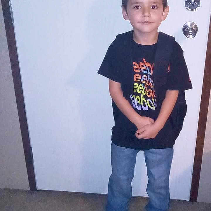 Kayden is registered to the contest to win money with this photo: accessories, advertisement, boy, child, clothing, door, face, footwear, head, jeans, male, pants, person, photography, portrait, poster, shoe, t_shirt, text, vest