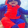 Steven Jr is registered to the contest to win money with this photo: baby, child, costume, spiderman, outdoor, sky, cloudy, smile, person, cute, red, blue, hood, mask, happy, holding, grass, playful, fun, portrait
