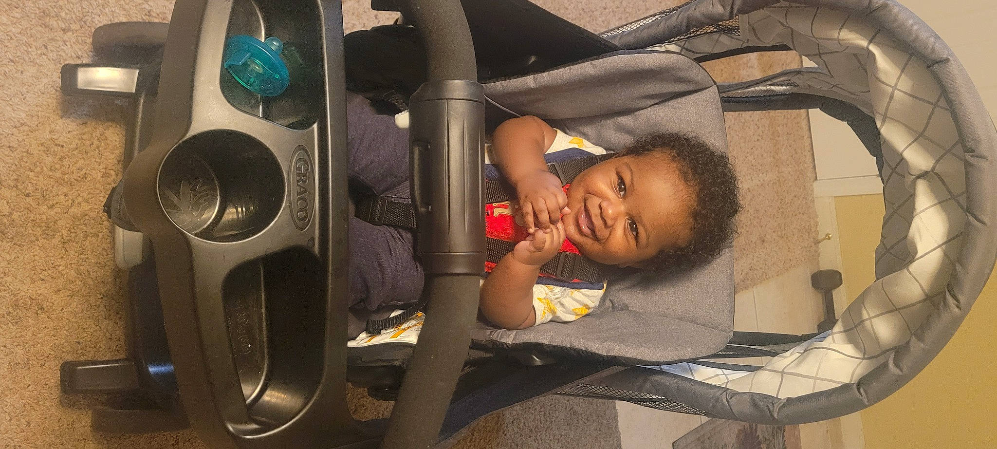 Eric is registered to the contest to win money with this photo: audio_equipment, auto_part, automotive_design, automotive_exterior, automotive_tire, automotive_wheel_system, baby, baby_products, car_seat, child, clothes_dryer, comfort, fun, joy, machine, motor_vehicle, person, rim, room, steering_wheel