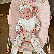 Eden joined the competition — help win amazing prizes! adorable, baby, baby_rocker, bib, child, comfort, cute, floral_pattern, footwear, happy, headband, indoor, infant, onesie, person, pink, playful, sitting, smiling, wooden_floor