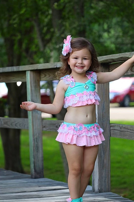 Swayze is registered to the contest to win money with this photo: abdomen, beauty, eye, face, fence, grass, hair, happy, head, joy, leg, magenta, person, pink, plant, shoe, shorts, smile, thigh, toddler