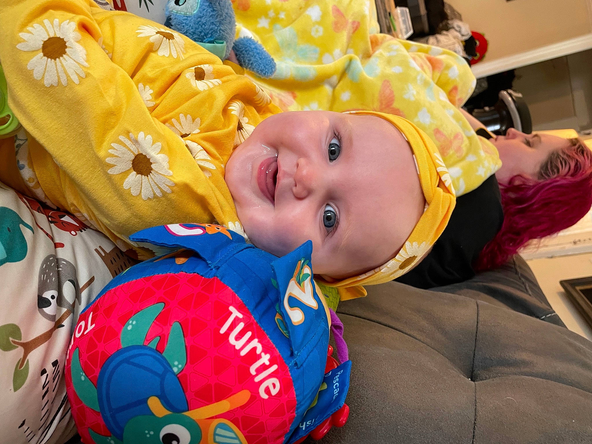 Madilyinn is registered to the contest to win money with this photo: baby, baby_toddler_clothing, ball, cheek, child, event, face, facial_expression, football, fun, happy, head, headwear, laugh, leisure, mammal, person, play, shelf, smile