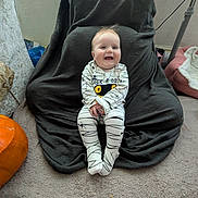 Elodie-Mae joined the competition — help win amazing prizes! baby, child, smile, onesie, spider_web, pumpkin, blanket, carpet, chair, indoor, happy, cute, person, floor, cozy, clothing, head, feet, home, sitting