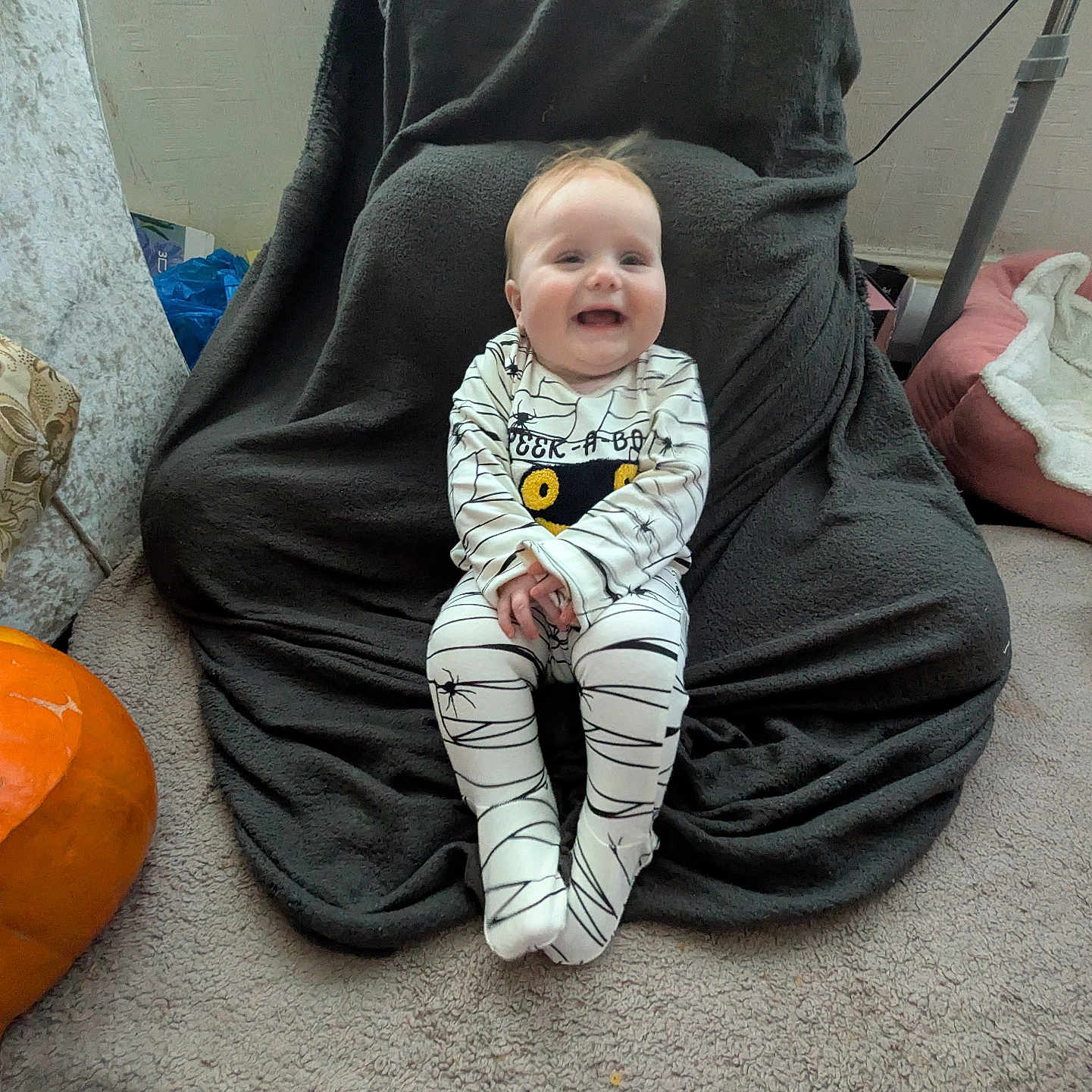 Elodie-Mae joined the competition — help win amazing prizes! baby, blanket, carpet, chair, child, clothing, cozy, cute, feet, floor, happy, head, home, indoor, onesie, person, pumpkin, sitting, smile, spider_web