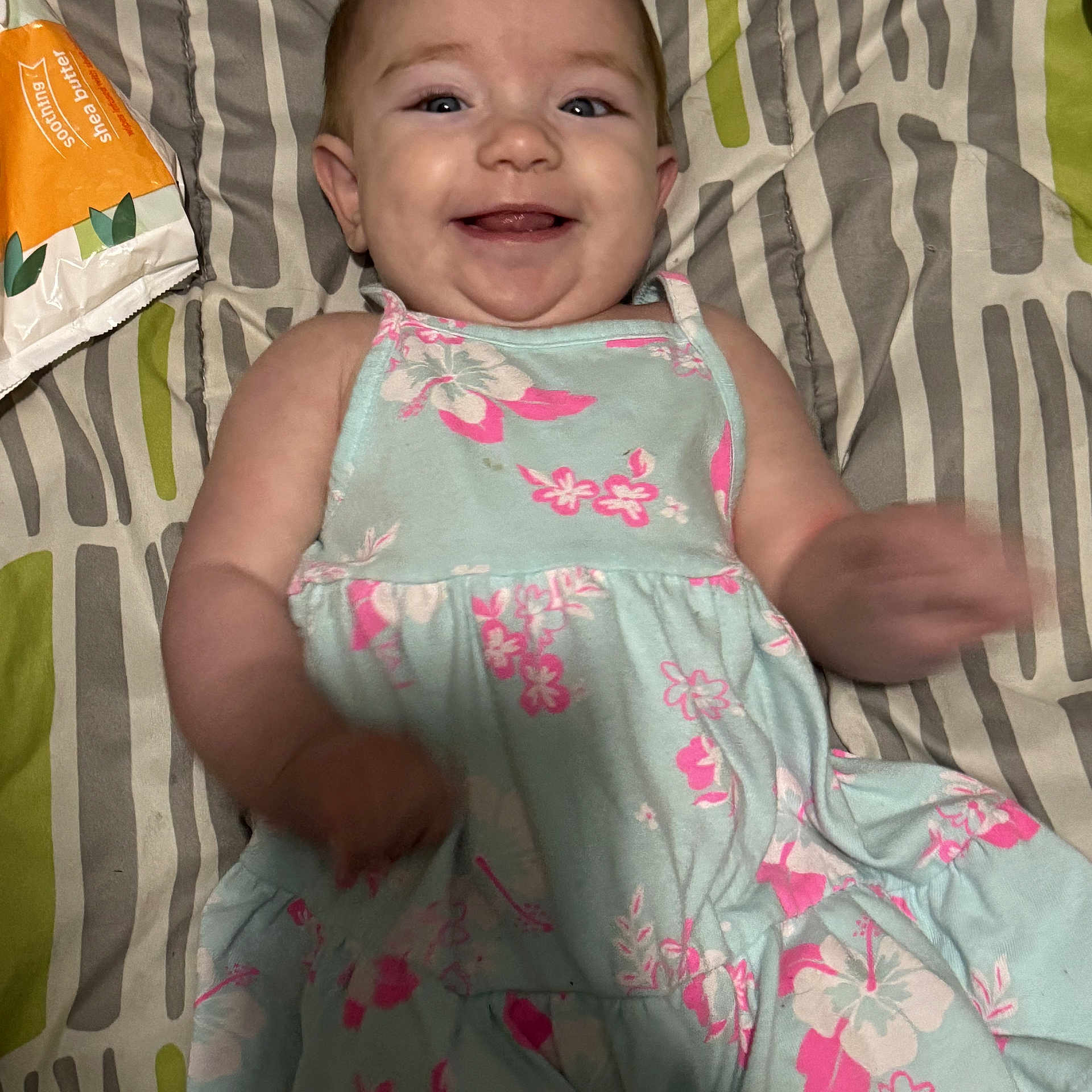 Rose joined the competition — help win amazing prizes! baby, child, smile, dress, floral, pattern, blanket, happy, face, infant, lying_down, cute, skin, hand, indoors, person, young, joy, toddler, clothing