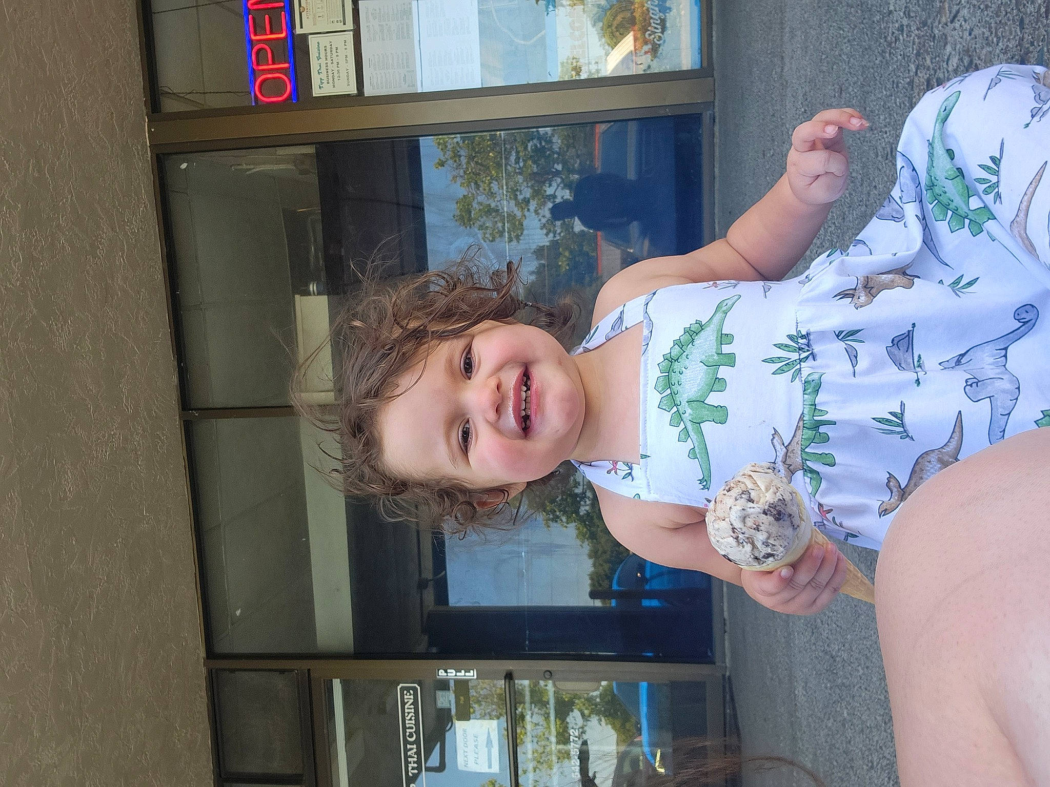 Lylah is registered to the contest to win money with this photo: abdomen, chest, child, elbow, fun, happy, human_leg, joy, leisure, pattern, person, plant, smile, t_shirt, thigh, toddler, tree, trunk, vacation, window