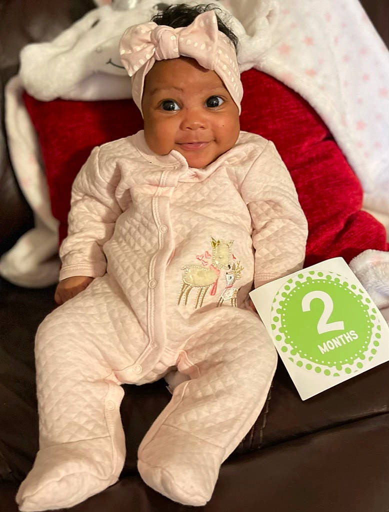 Sanaiya joined the competition — help win amazing prizes! baby, baby_products, baby_toddler_clothing, cheek, child, comfort, eye, face, happy, head, headgear, headwear, linens, outerwear, person, sitting, skin, sleeve, smile, t_shirt